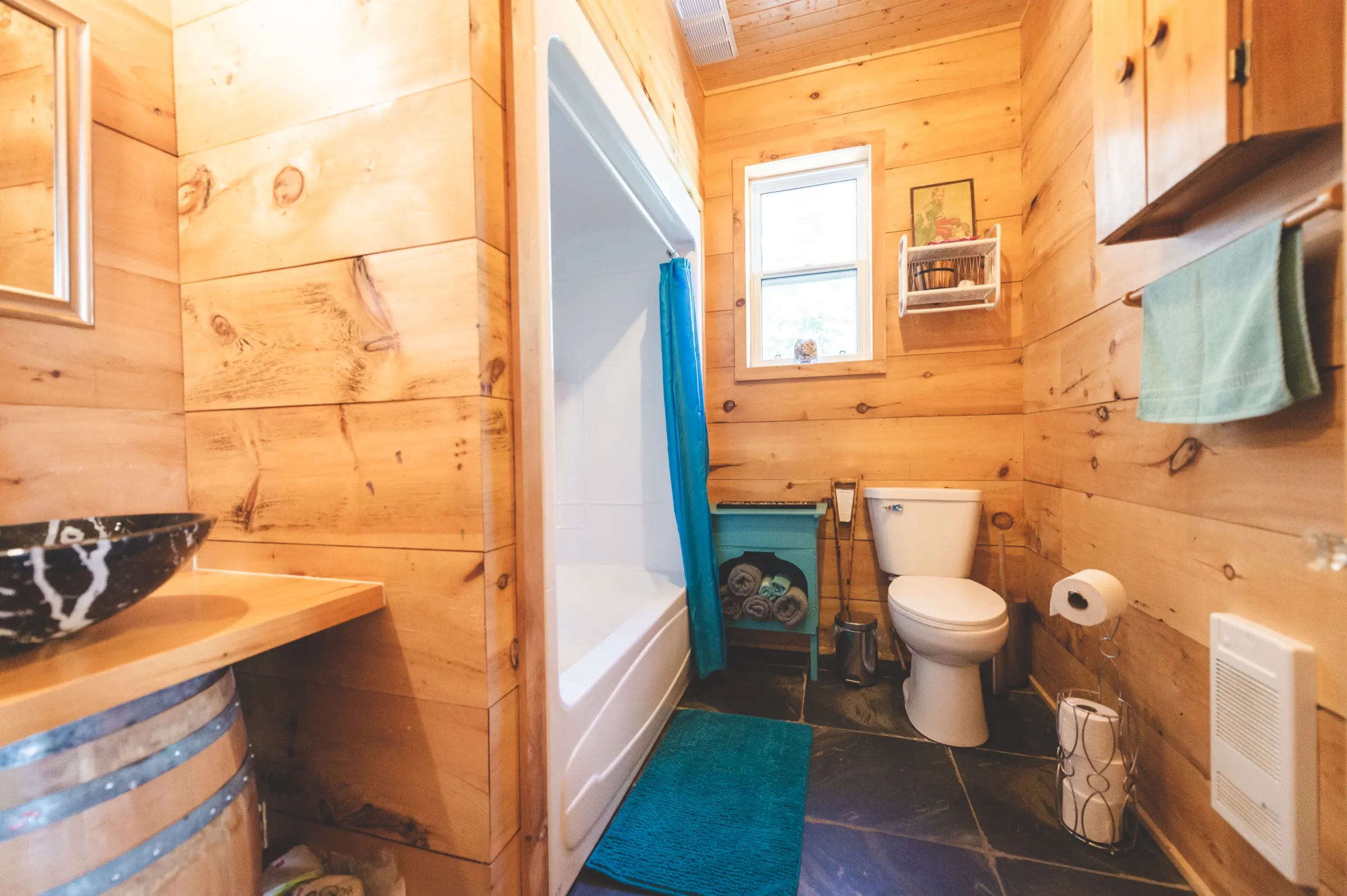 The chalet bathroom, with a vanity and shower under pine trim