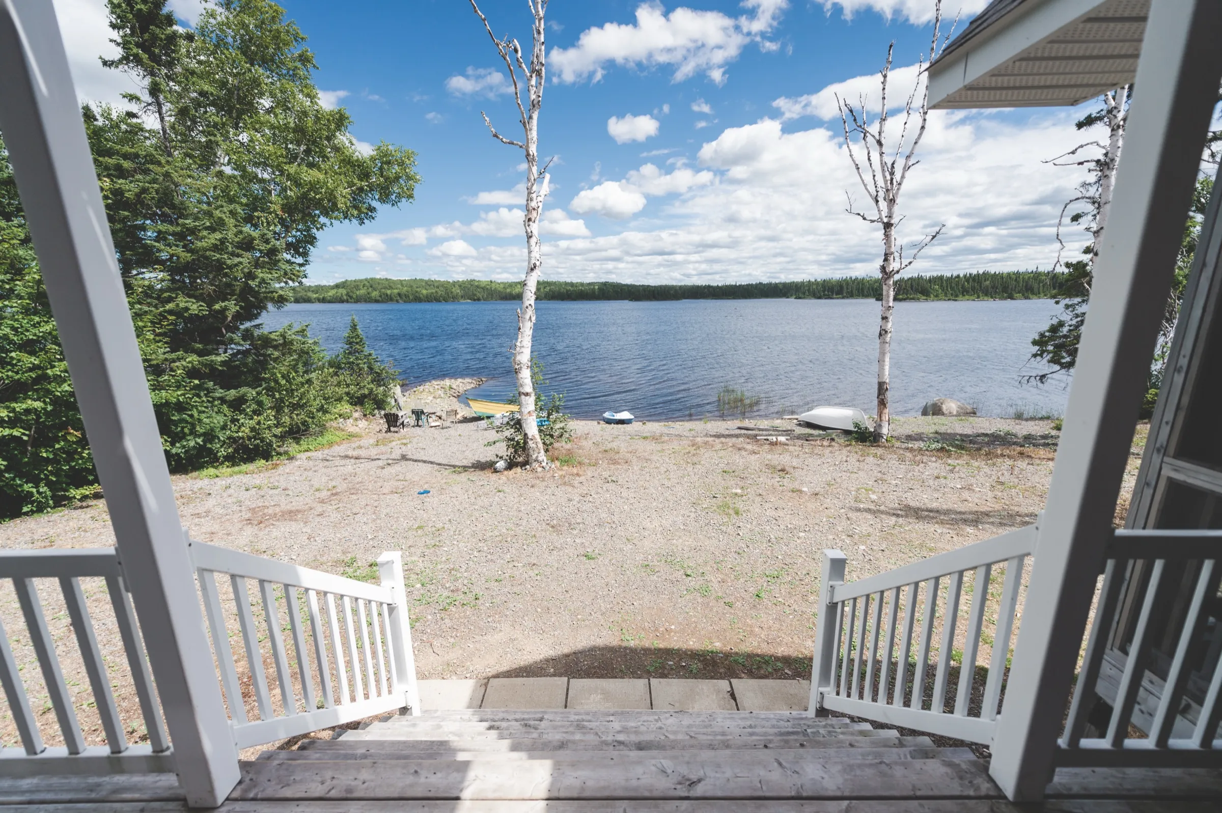 The chalet deck looking out over its own stretch of shoreline on Monroe's Pond, with wooded shore on the far side