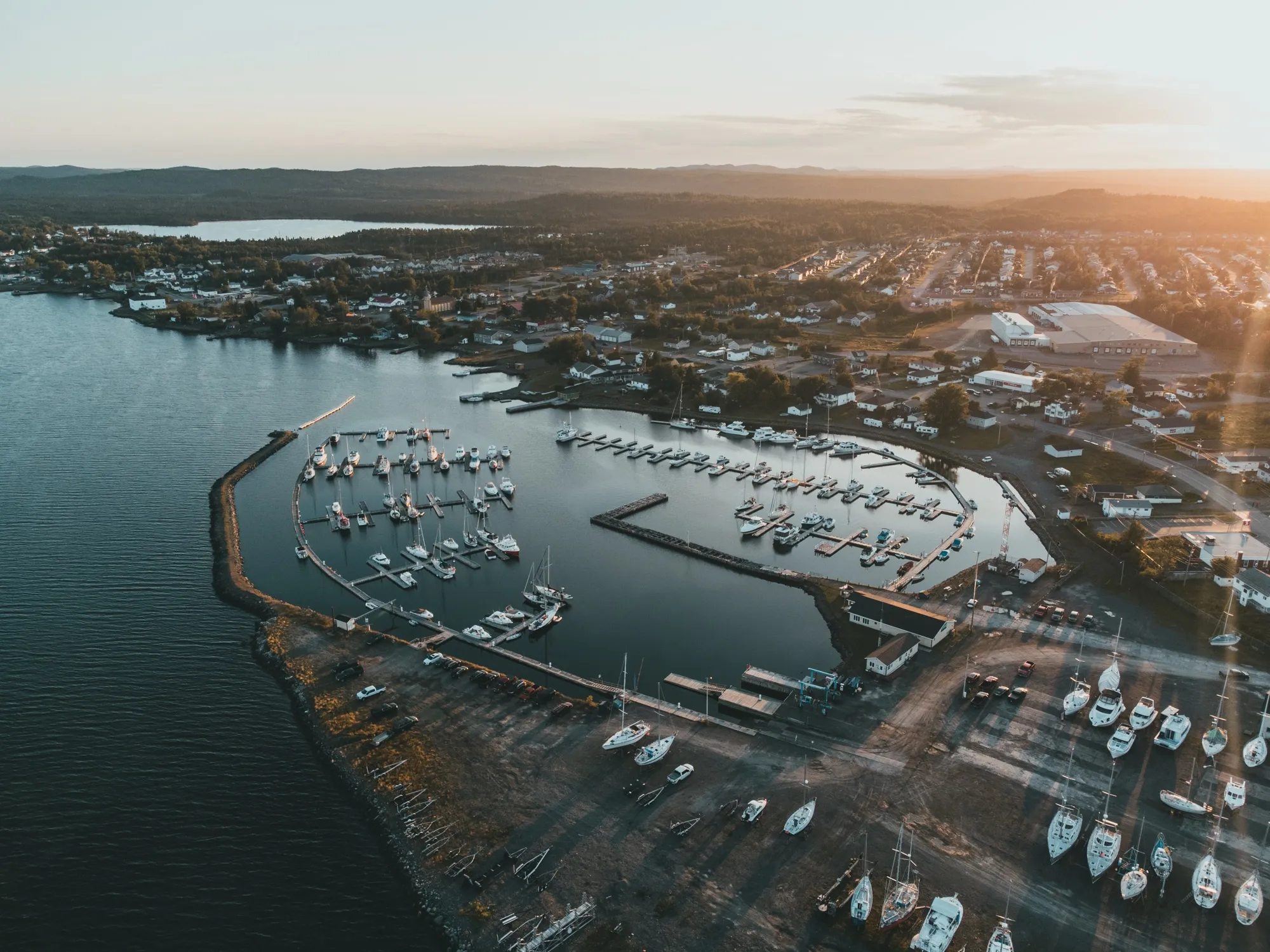 The marina and boatyard at sunset, hauled-out sailboats standing on their cradles