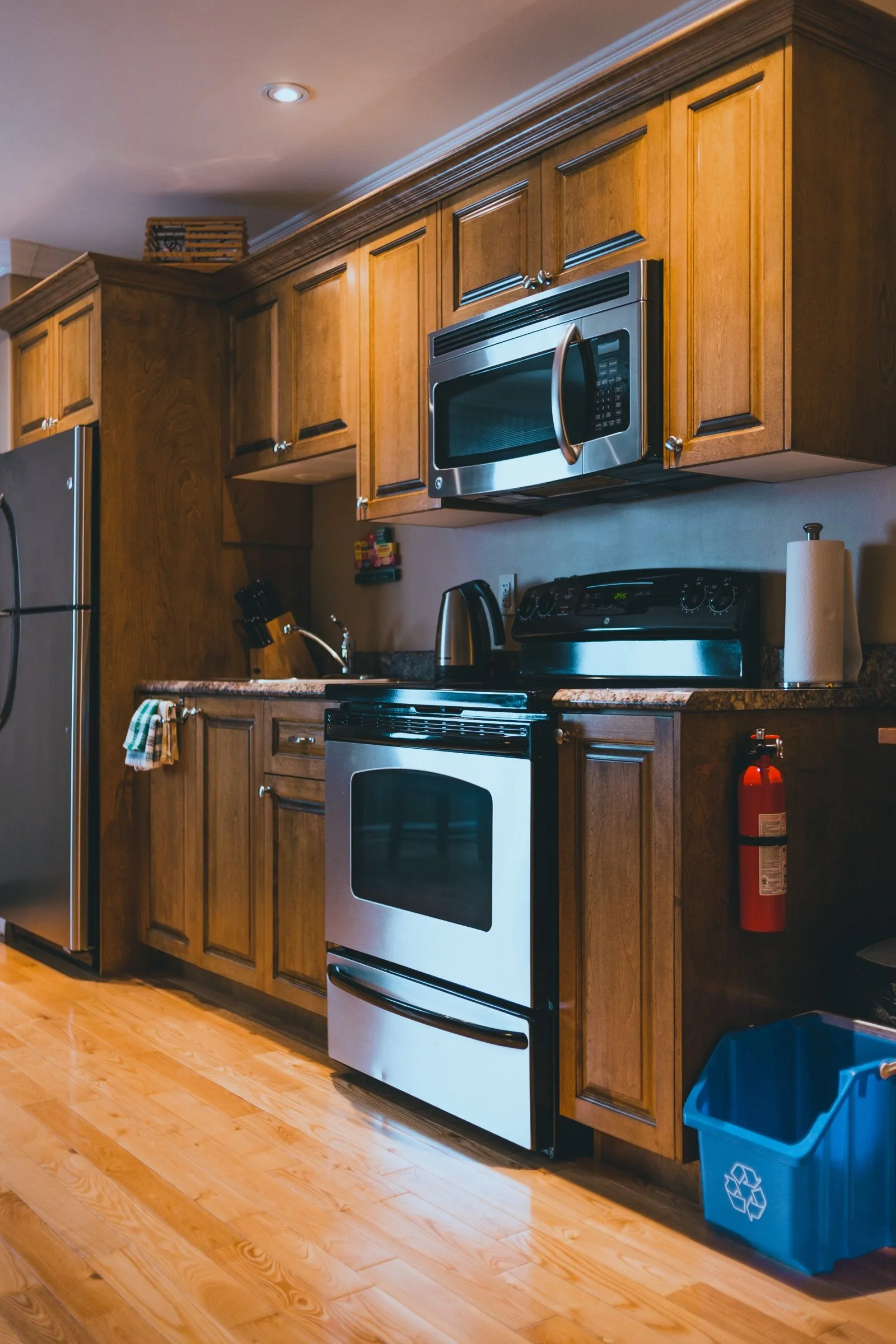 Full efficiency kitchen in a suite, with stainless fridge, stove and over-range microwave